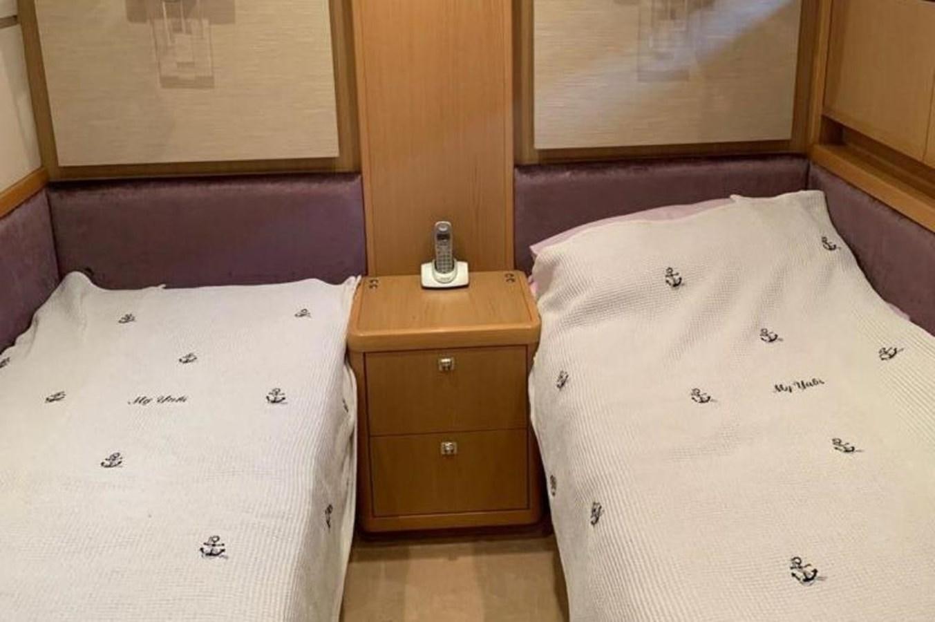 a room with a bed and a dresser aboard PRINCESS 95 Yacht for Sale