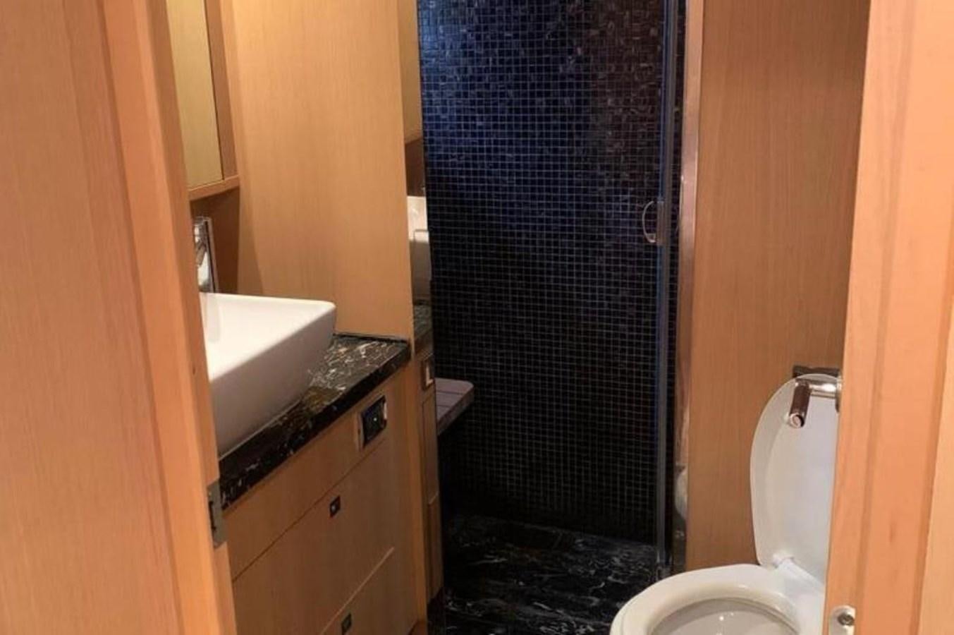 a bathroom with a black shower curtain aboard PRINCESS 95 Yacht for Sale