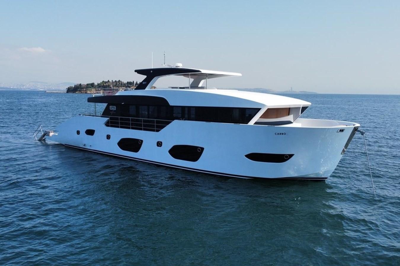 a white yacht in the water aboard CARBO Yacht for Sale