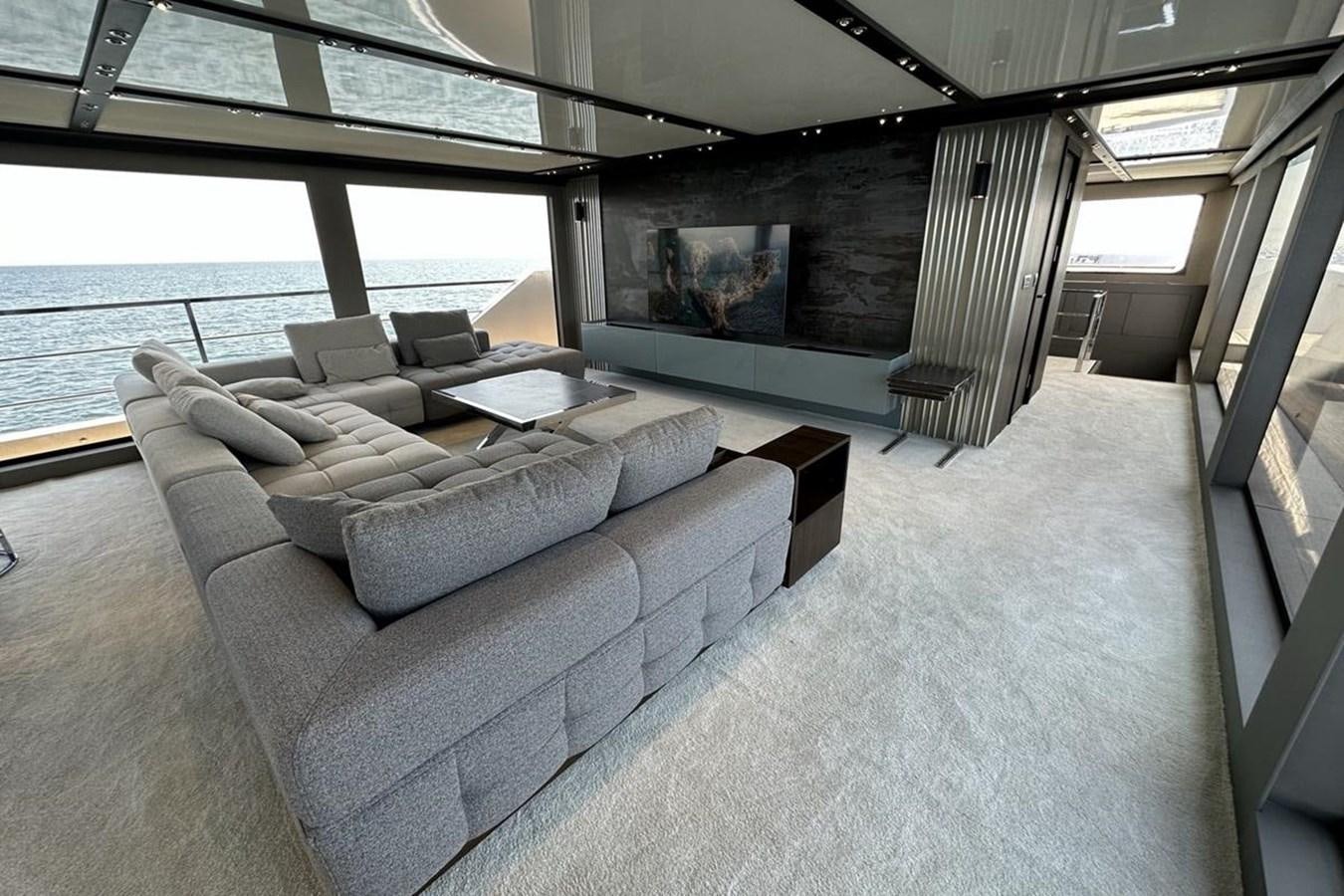 a room with couches and a tv aboard CARBO Yacht for Sale