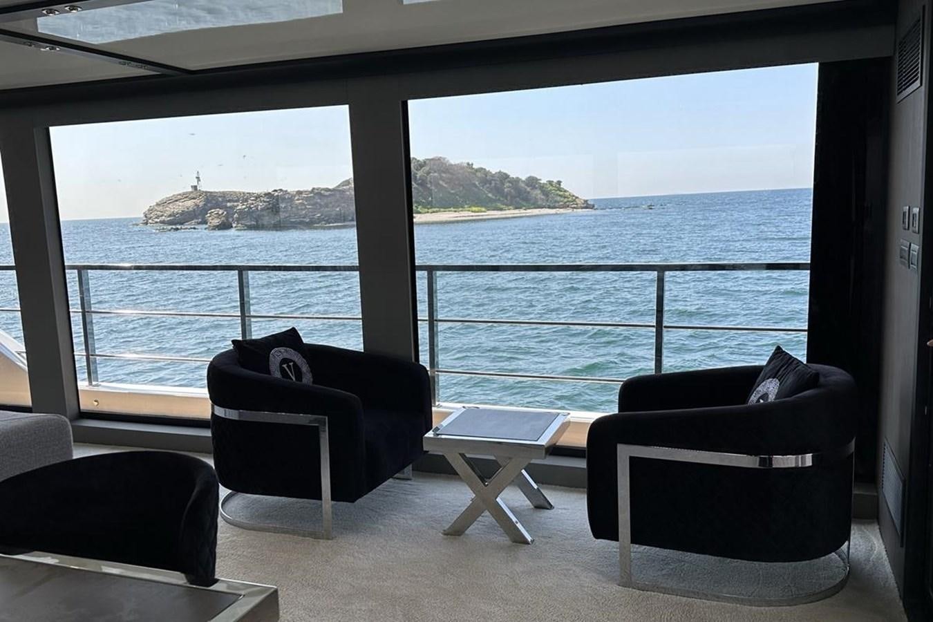 a room with a view of the ocean and a couple of chairs aboard CARBO Yacht for Sale