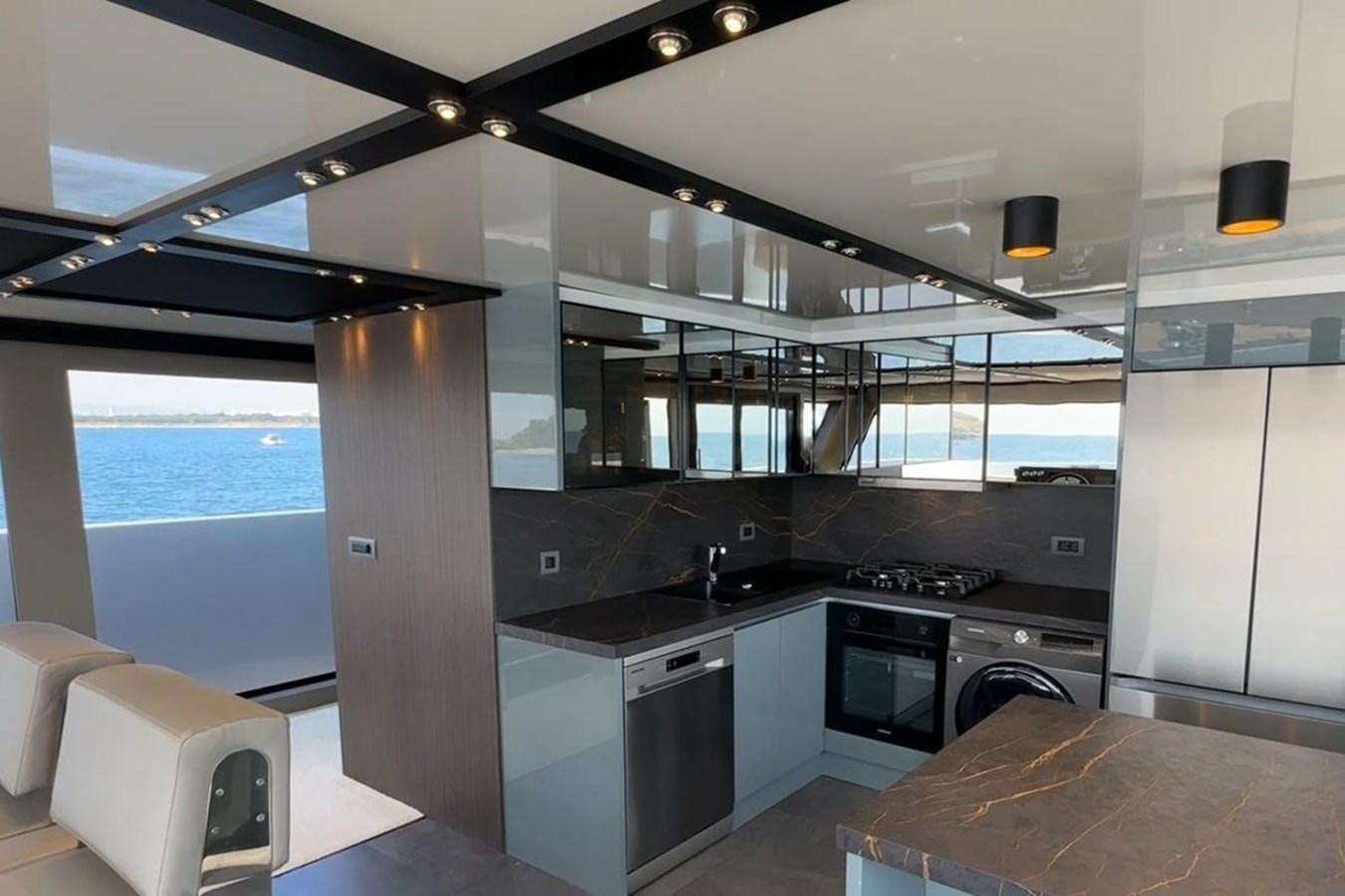 a kitchen with a large window aboard CARBO Yacht for Sale