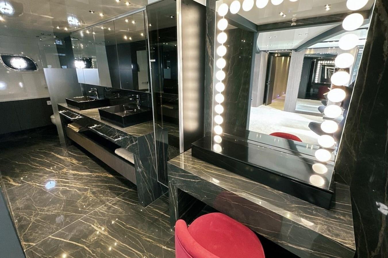 a room with a piano and a large mirror aboard CARBO Yacht for Sale
