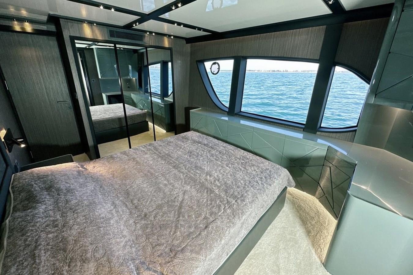 a room with a bed and a large window aboard CARBO Yacht for Sale