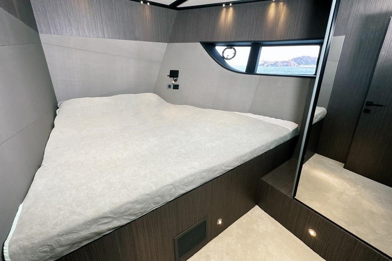 a bed with a white sheet aboard CARBO Yacht for Sale