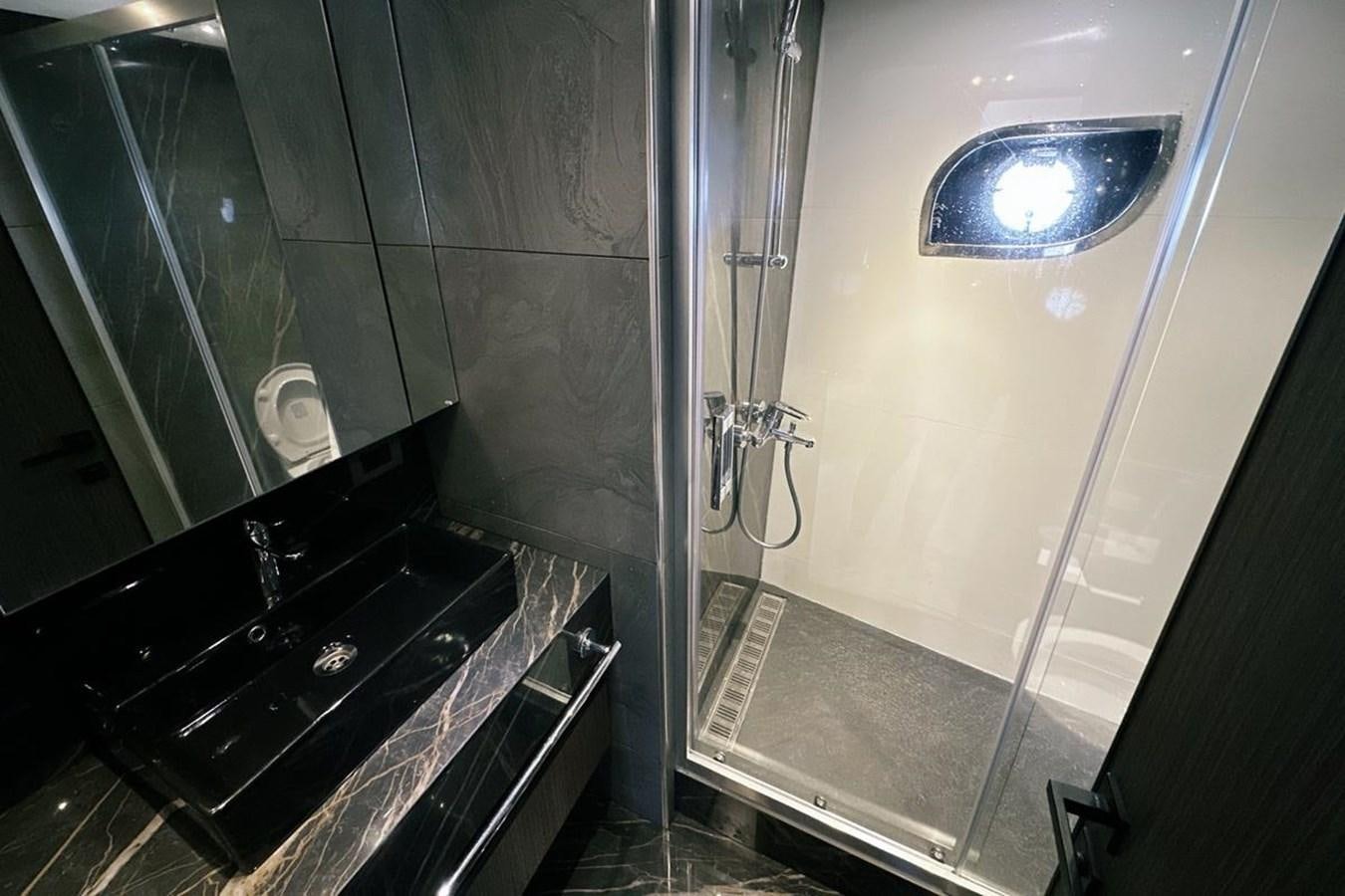 a bathroom with a glass shower aboard CARBO Yacht for Sale
