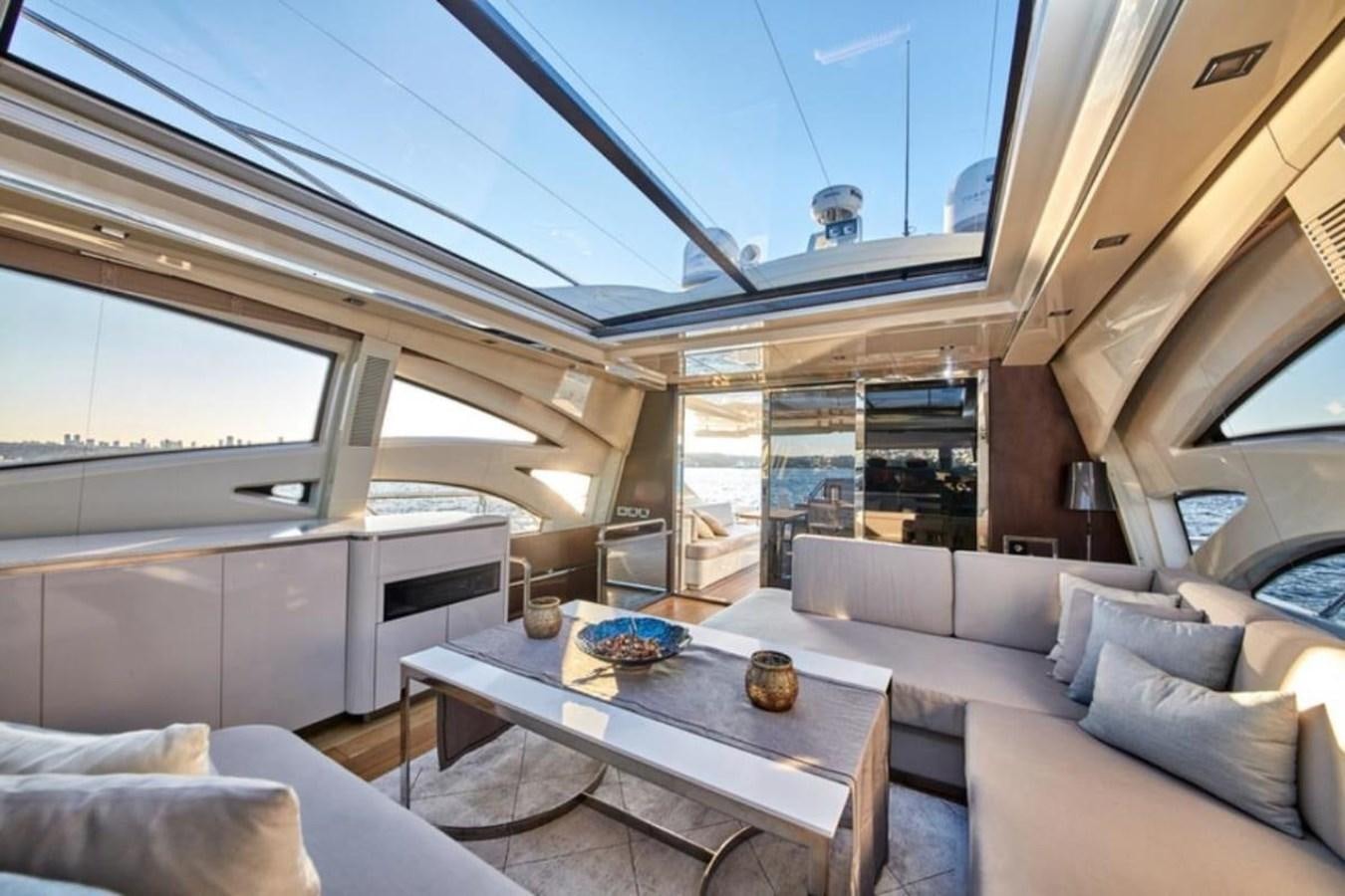 a room with a couch and a table aboard AZIMUT 98 Yacht for Sale