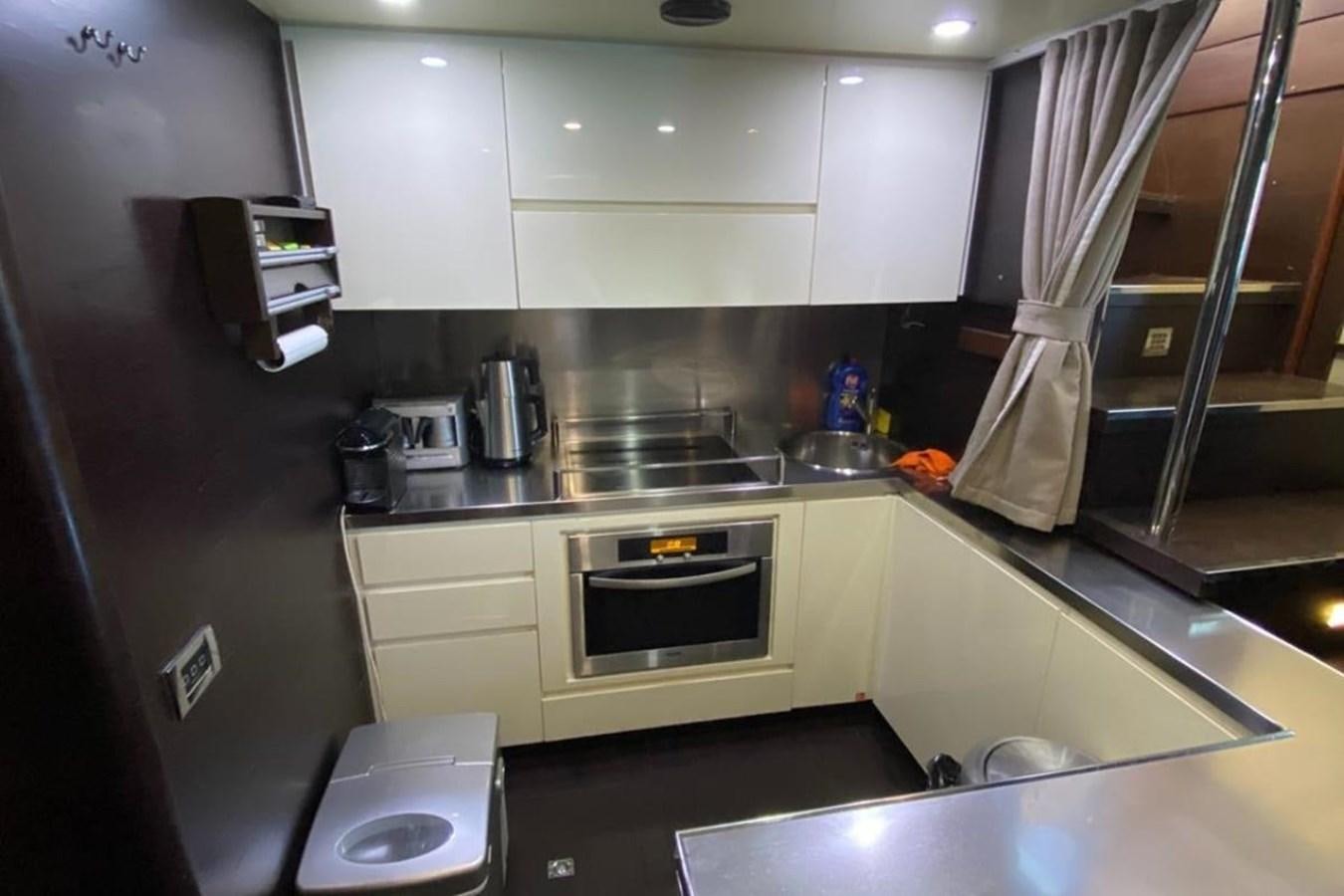 a kitchen with a stove and oven aboard AZIMUT 98 Yacht for Sale