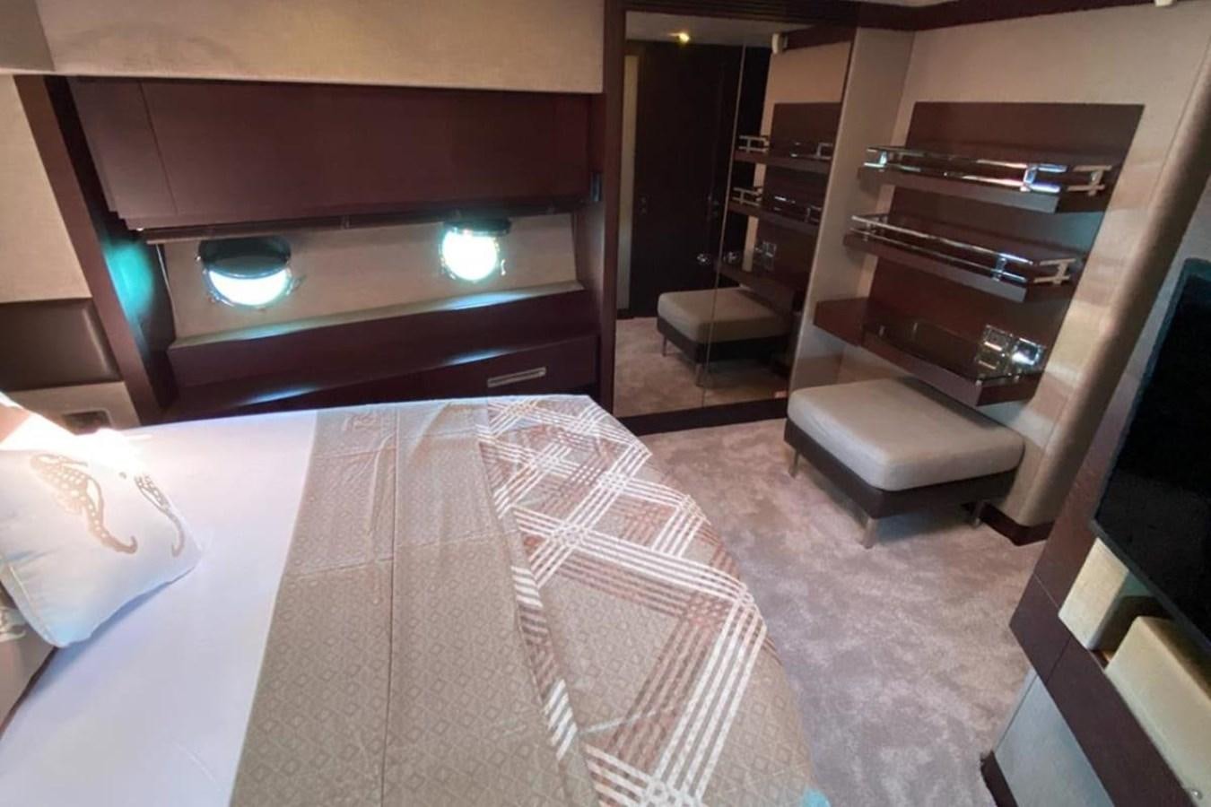 a bedroom with a bed and a shelf aboard AZIMUT 98 Yacht for Sale
