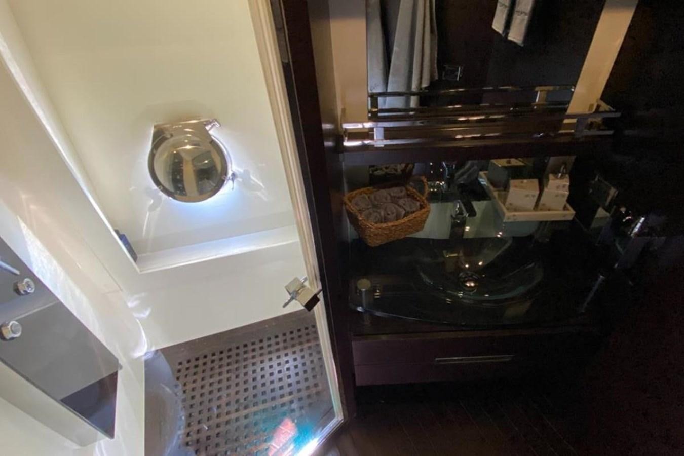 a kitchen with a sink and a mirror aboard AZIMUT 98 Yacht for Sale
