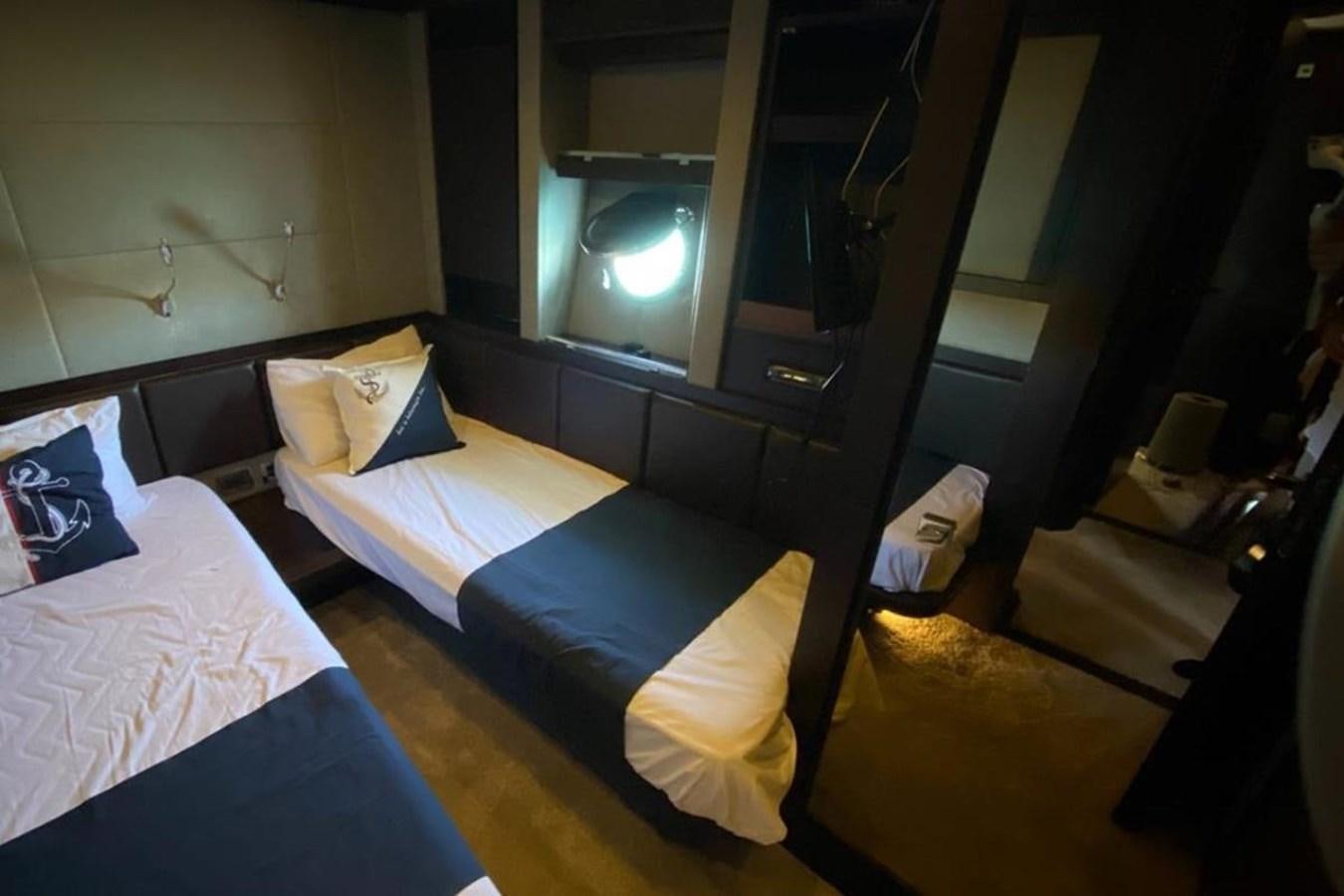 a room with a bed and a television aboard AZIMUT 98 Yacht for Sale