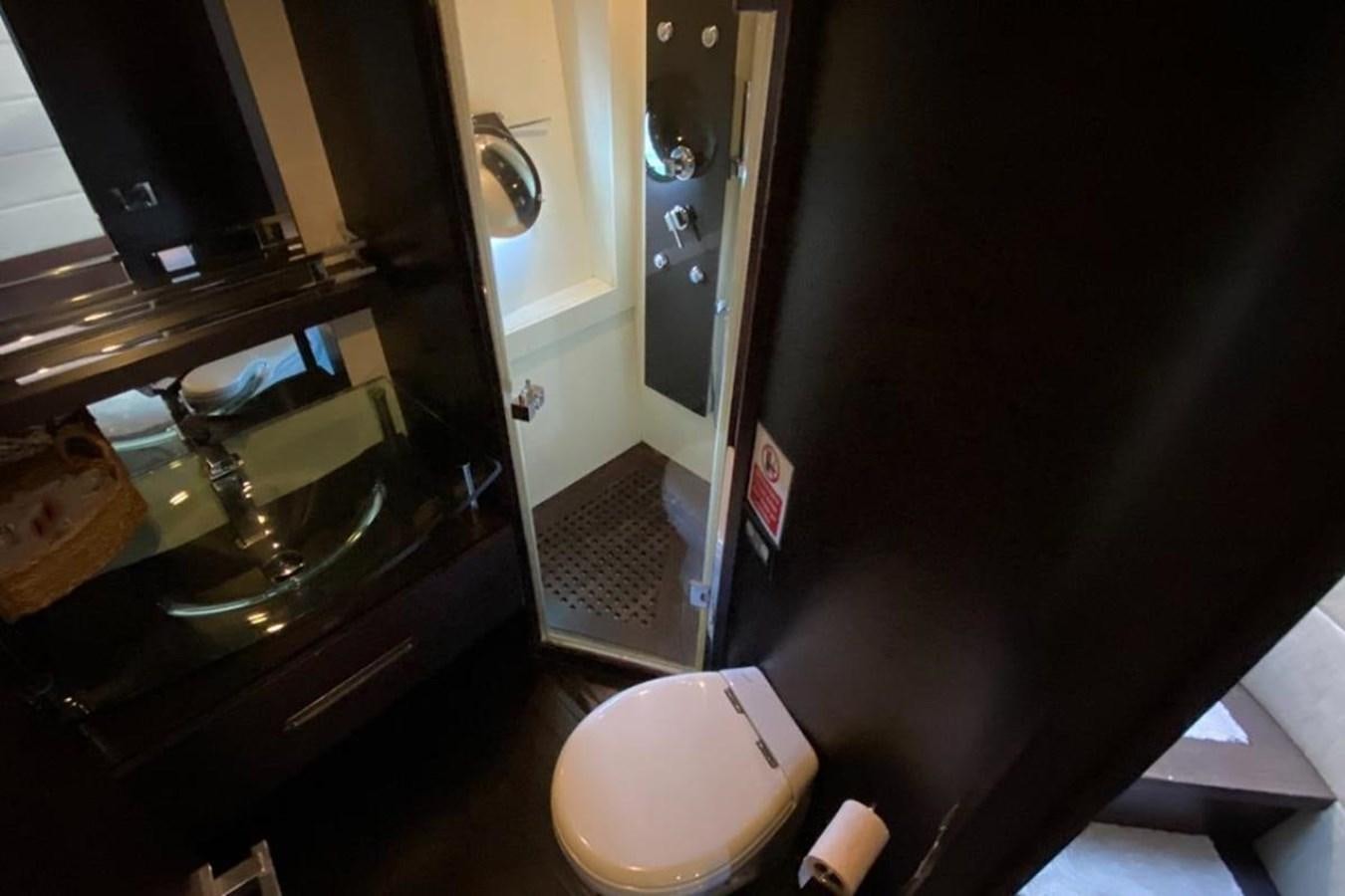 a bathroom with a toilet and a sink aboard AZIMUT 98 Yacht for Sale