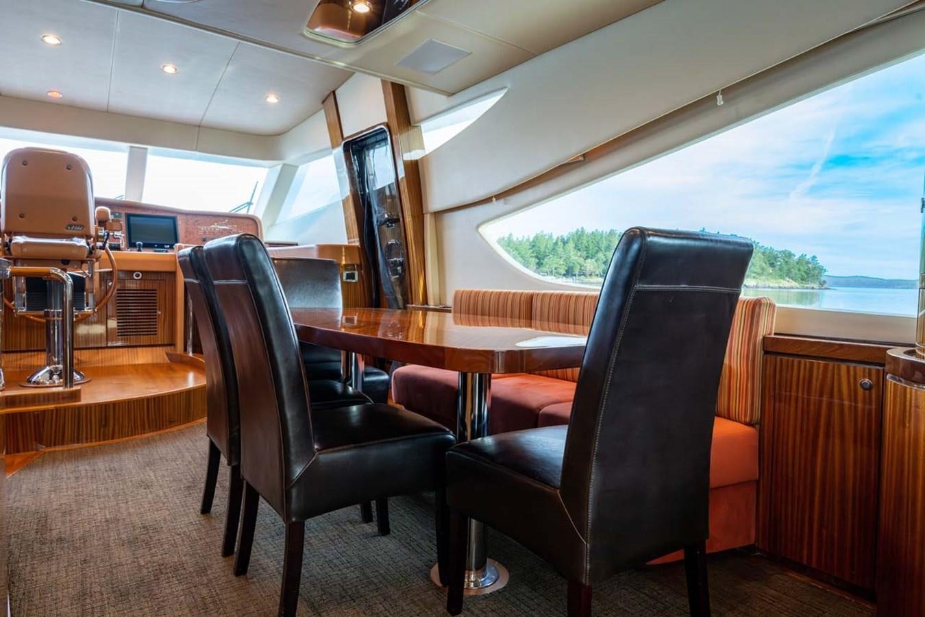 a room with a table and chairs aboard BELLA SOGNO Yacht for Sale