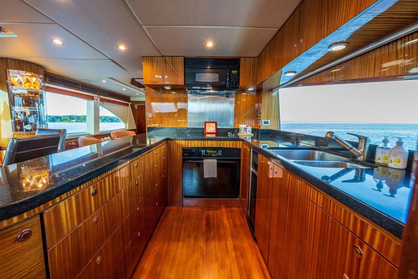 a kitchen with wooden cabinets aboard BELLA SOGNO Yacht for Sale