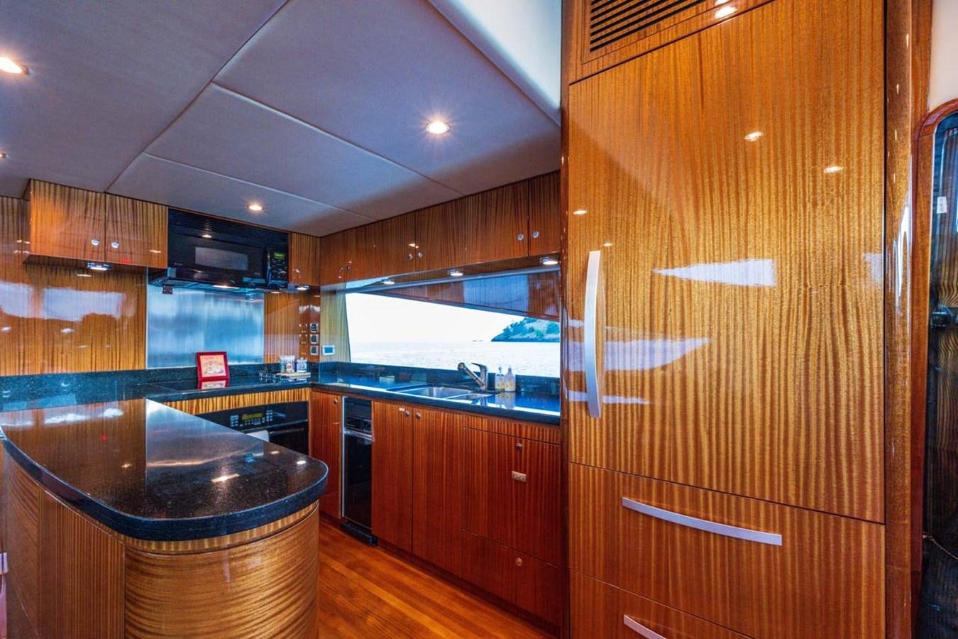a kitchen with wooden cabinets aboard BELLA SOGNO Yacht for Sale