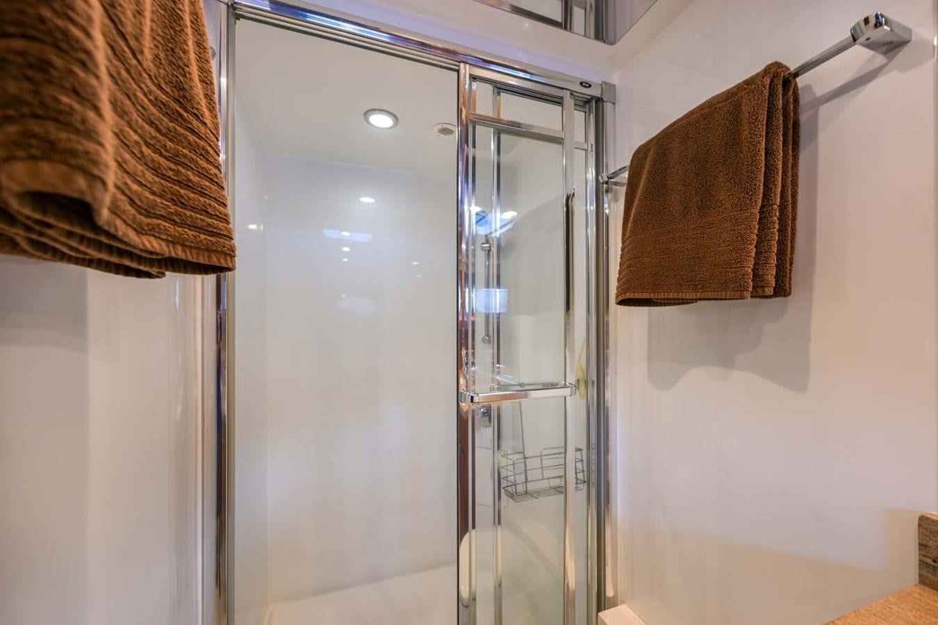 a bathroom with a glass shower aboard BELLA SOGNO Yacht for Sale