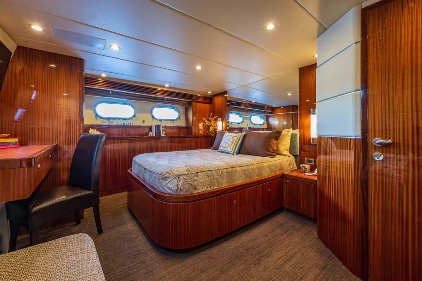 a bedroom with a bed and a desk aboard BELLA SOGNO Yacht for Sale