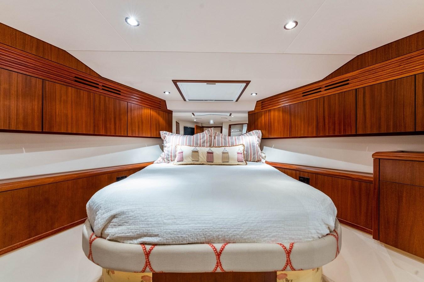 a room with a bed and a wood wall aboard RUMOURS Yacht for Sale