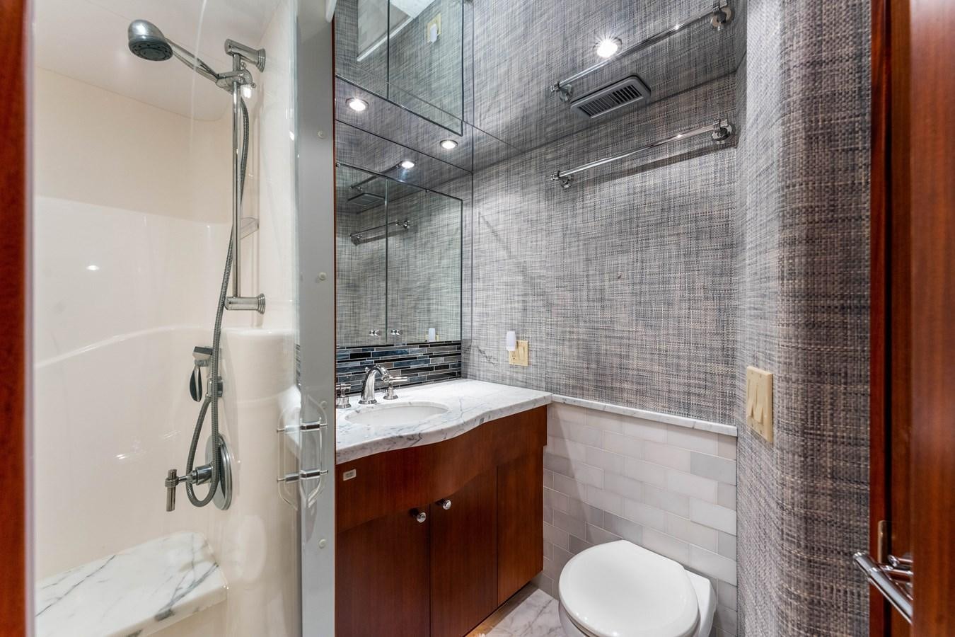 a bathroom with a shower and sink aboard RUMOURS Yacht for Sale