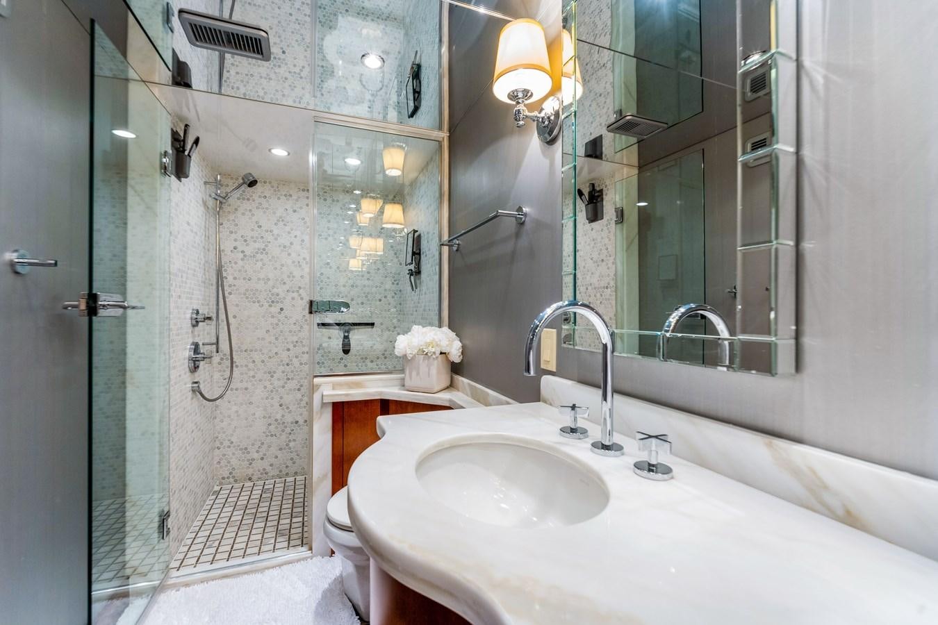 a bathroom with a sink and a shower aboard RUMOURS Yacht for Sale