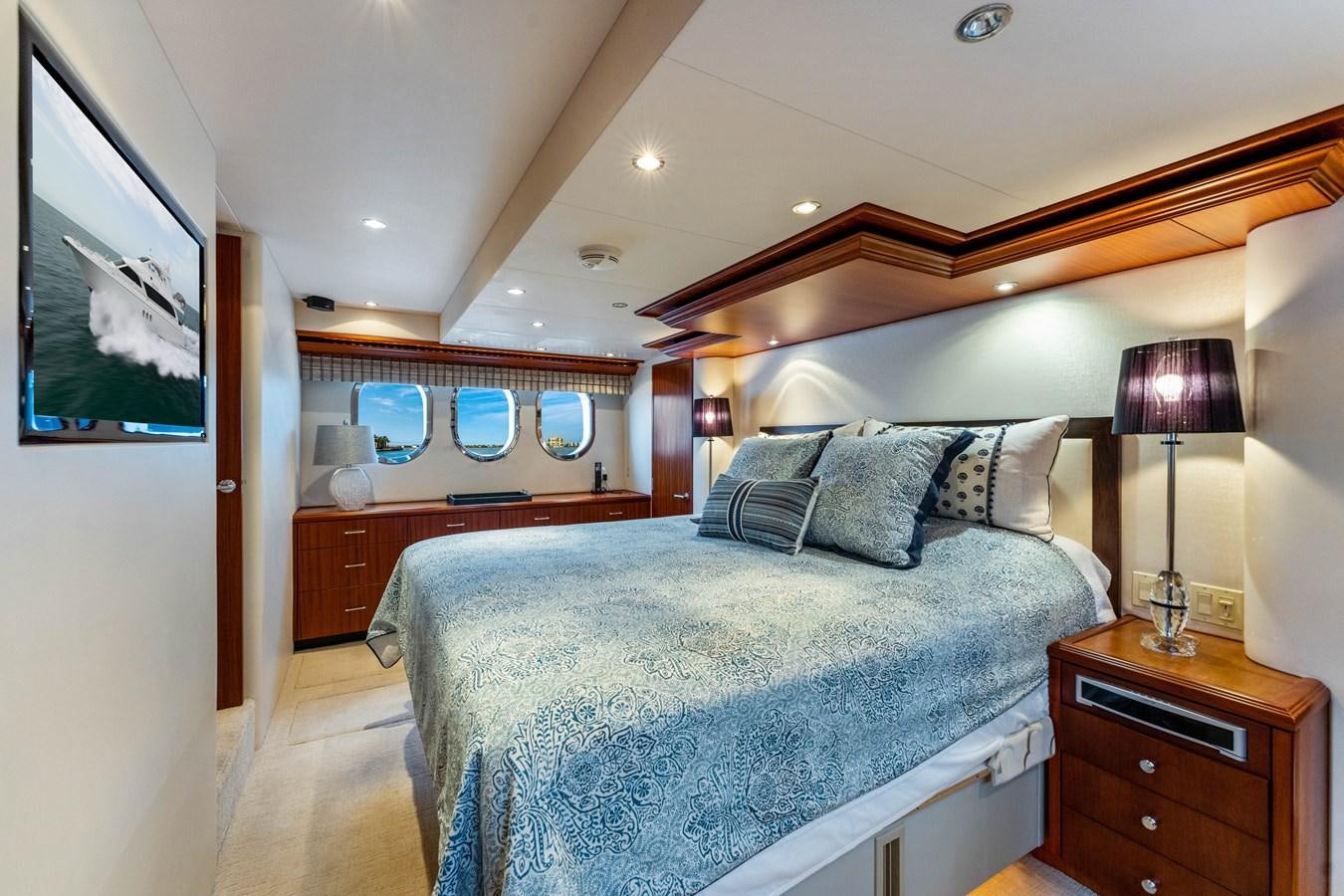 a bedroom with a bed and a desk aboard RUMOURS Yacht for Sale