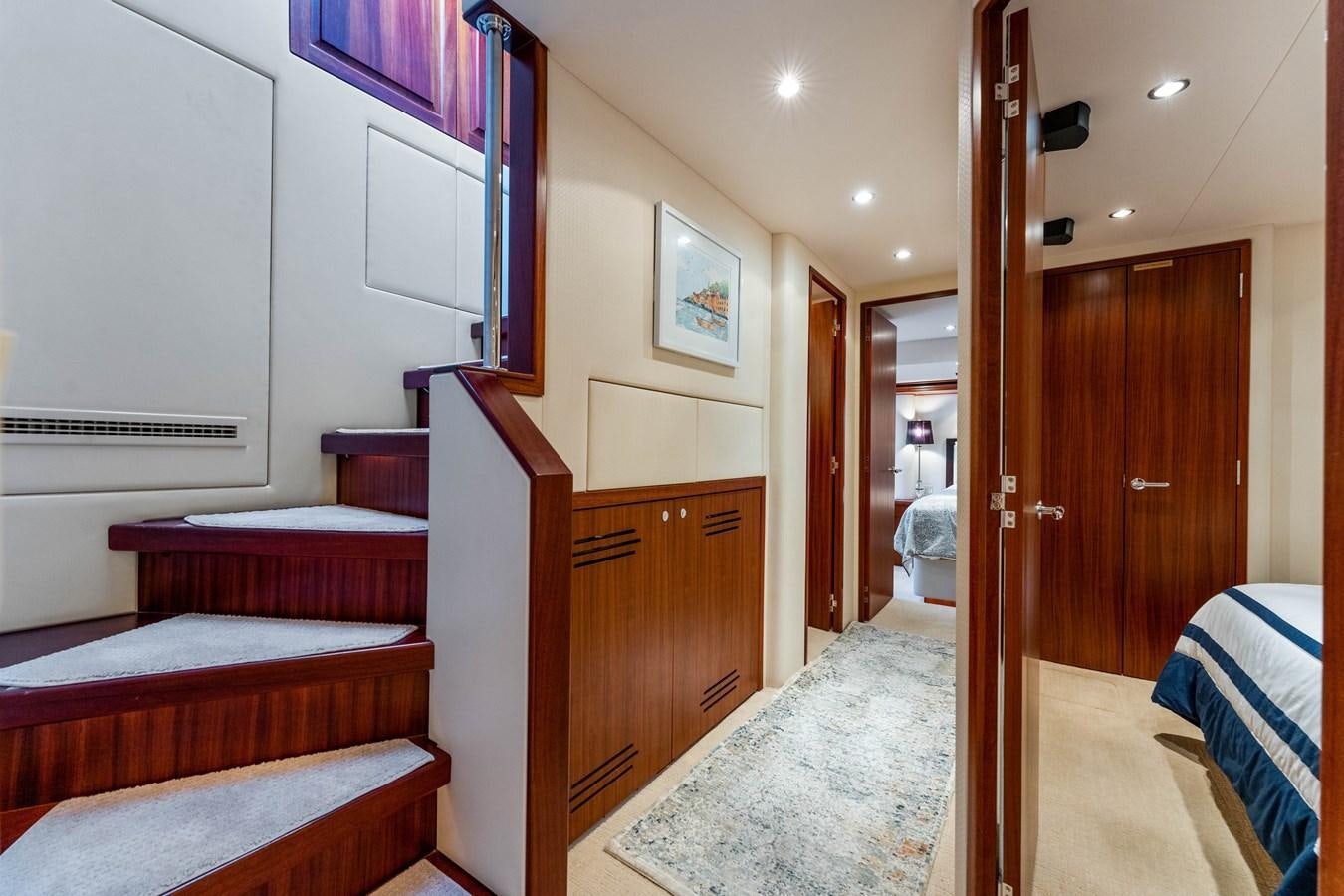 a bedroom with a bed and a closet aboard RUMOURS Yacht for Sale