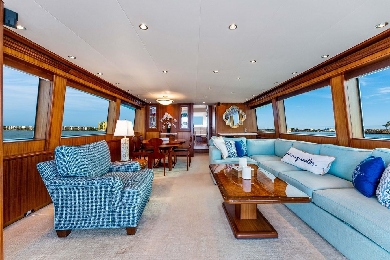 a living room with a couch and a coffee table aboard RUMOURS Yacht for Sale