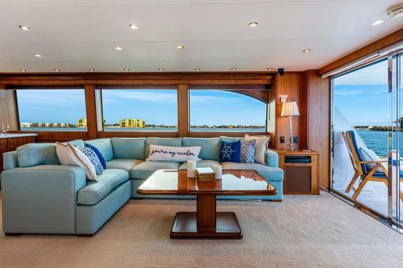 a living room with a couch and a coffee table aboard RUMOURS Yacht for Sale