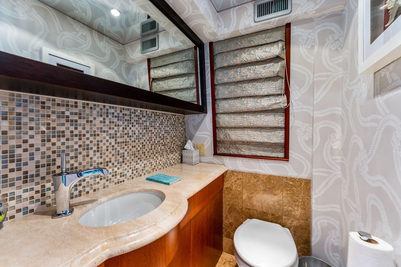 a bathroom with a sink and toilet aboard RUMOURS Yacht for Sale