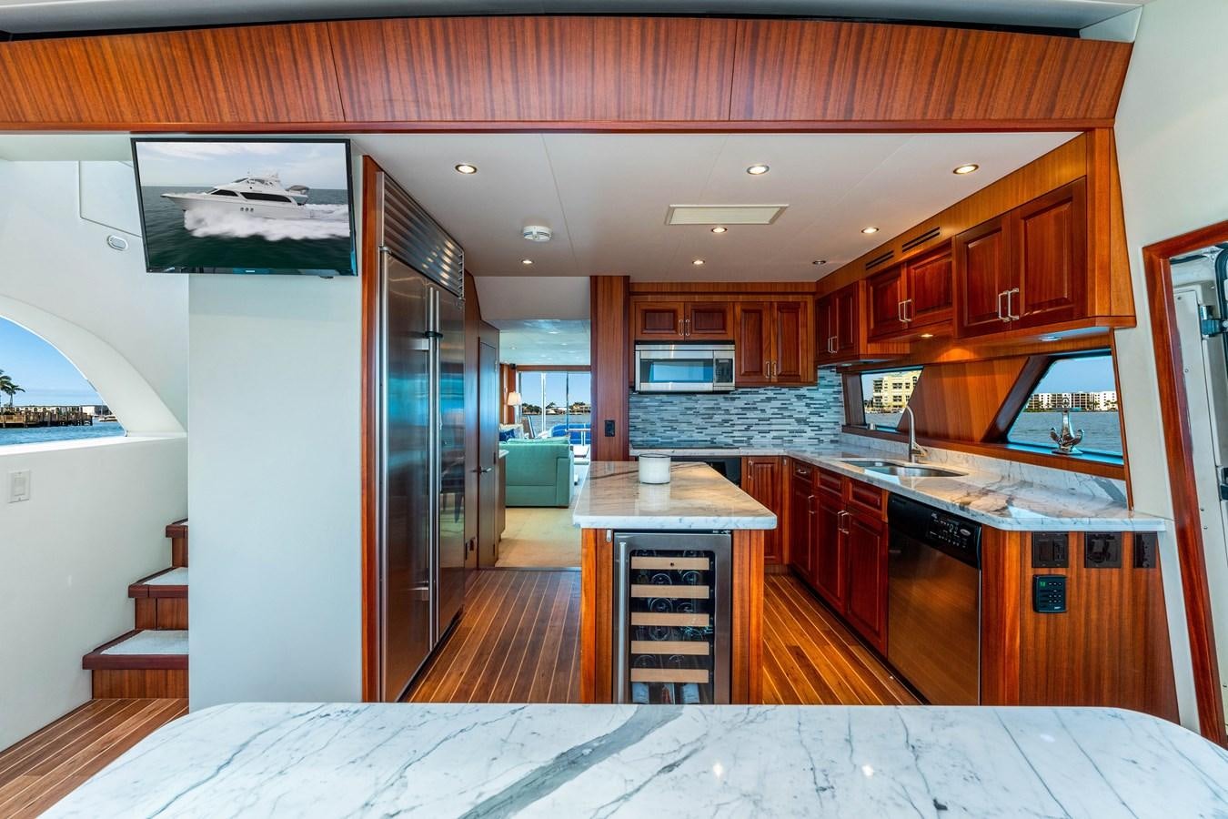 a kitchen with wooden cabinets aboard RUMOURS Yacht for Sale