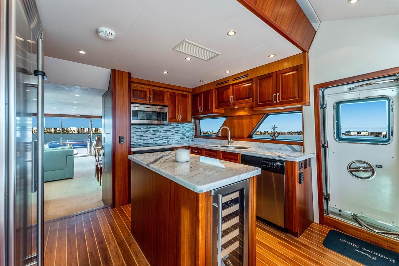 a kitchen with wooden cabinets aboard RUMOURS Yacht for Sale