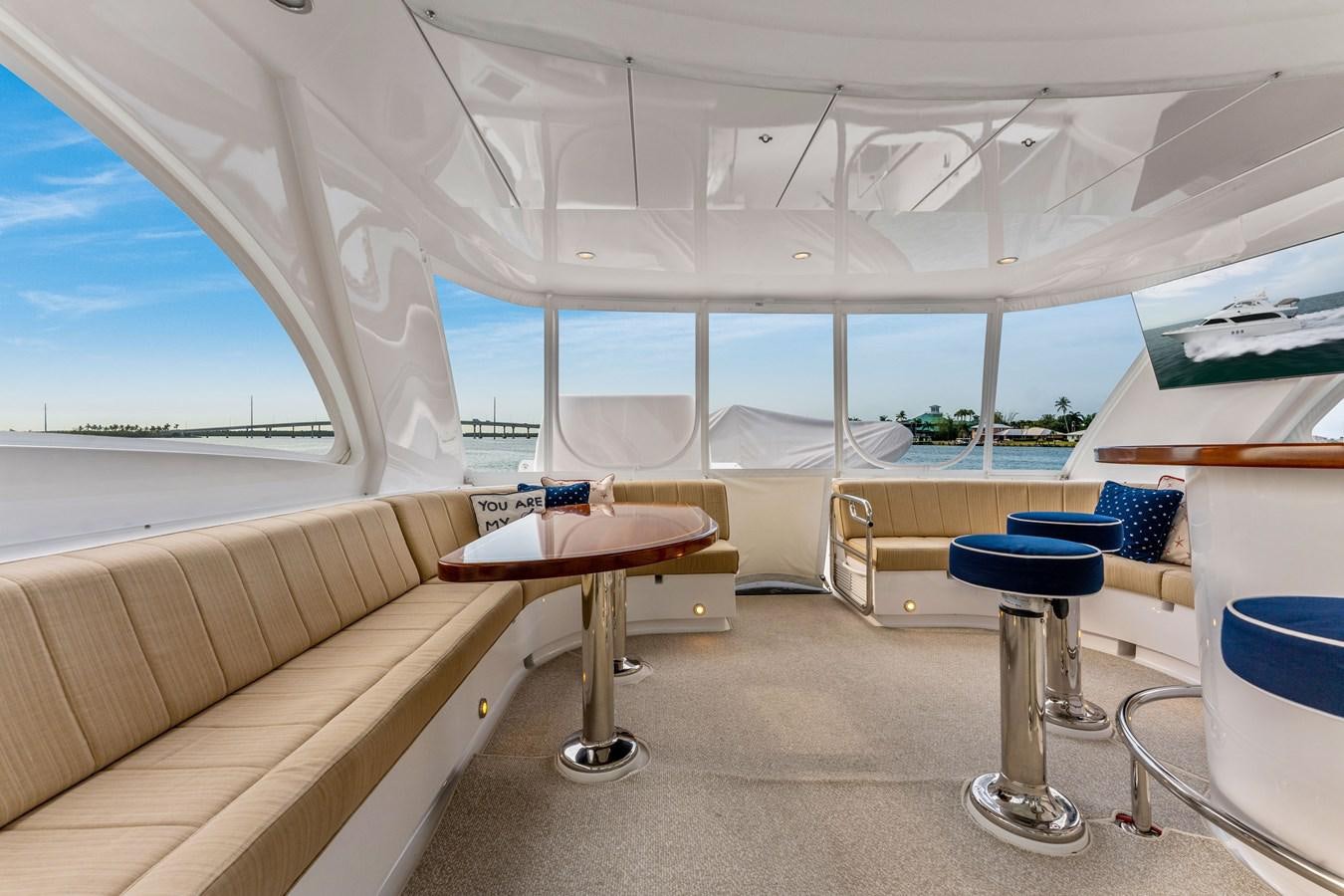 a room with a table and chairs aboard RUMOURS Yacht for Sale