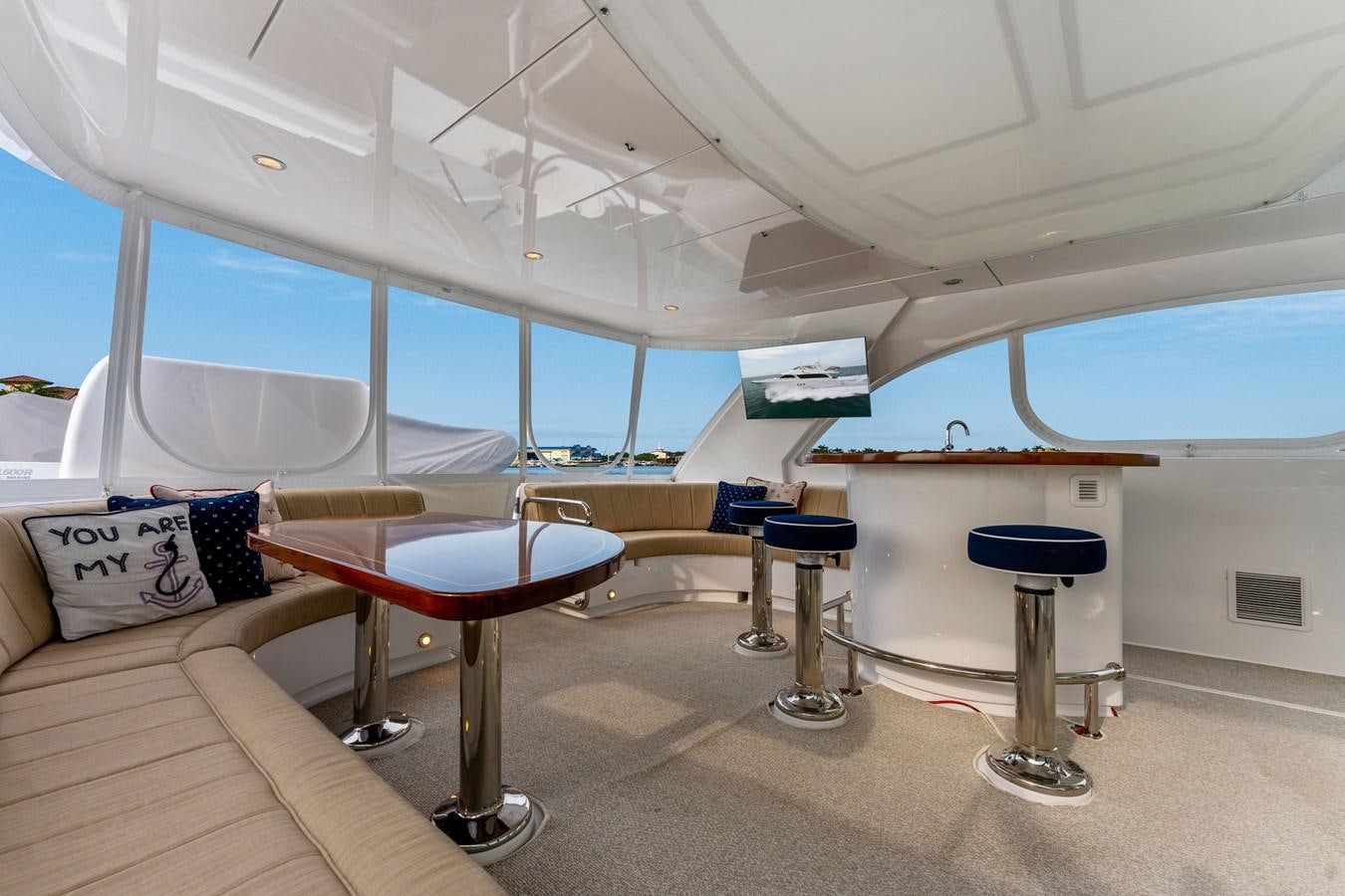 a room with a table and chairs aboard RUMOURS Yacht for Sale