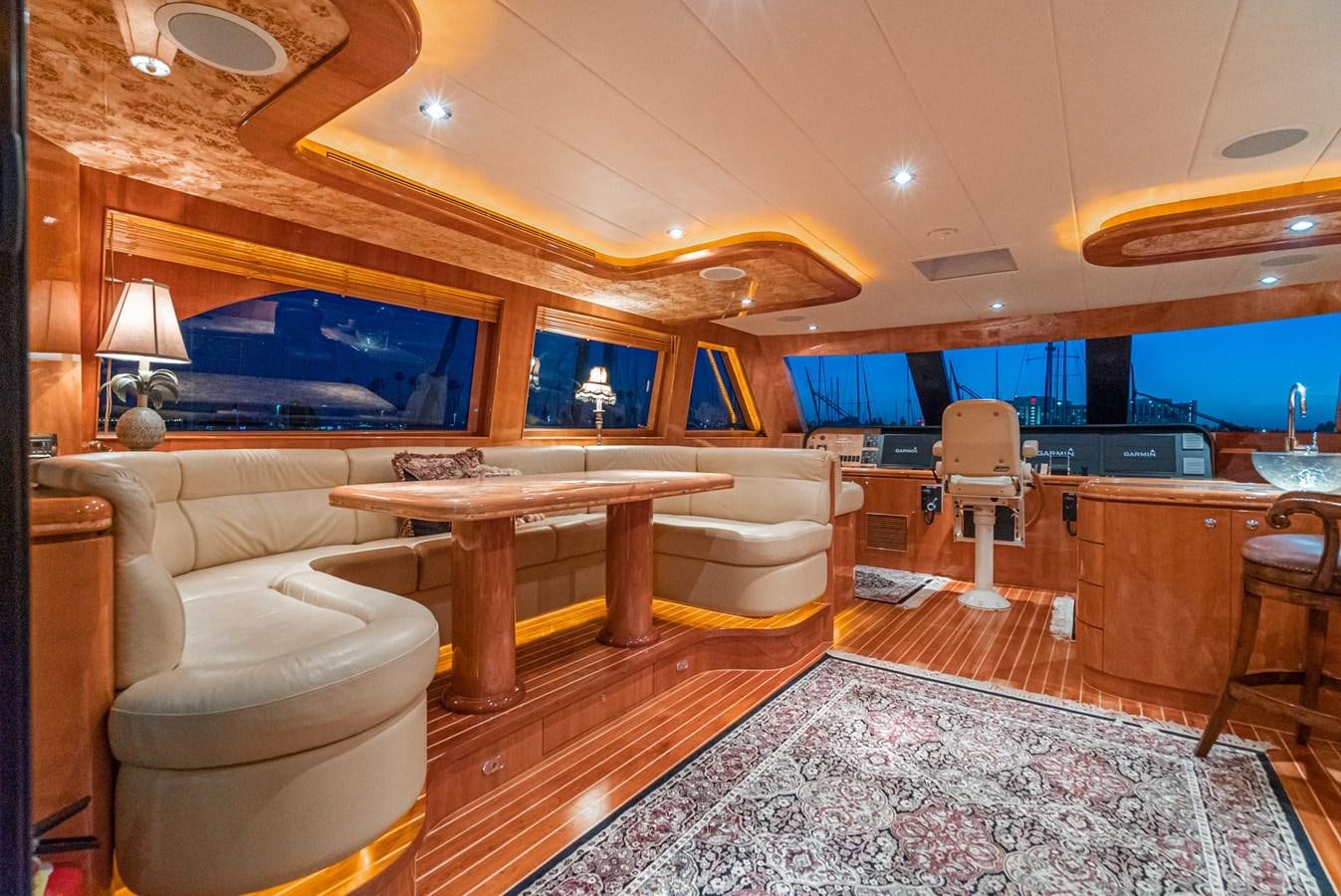 a room with a table and chairs aboard LIBERTY Yacht for Sale