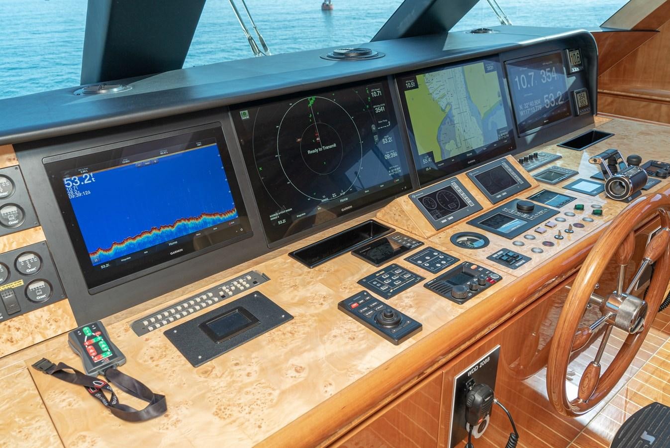 a wooden table with a computer and a television on it aboard LIBERTY Yacht for Sale