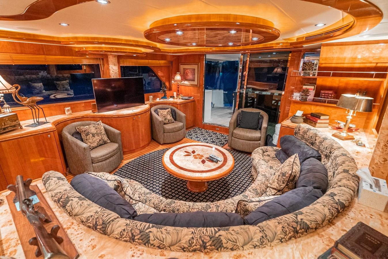 a living room with a large sofa aboard LIBERTY Yacht for Sale