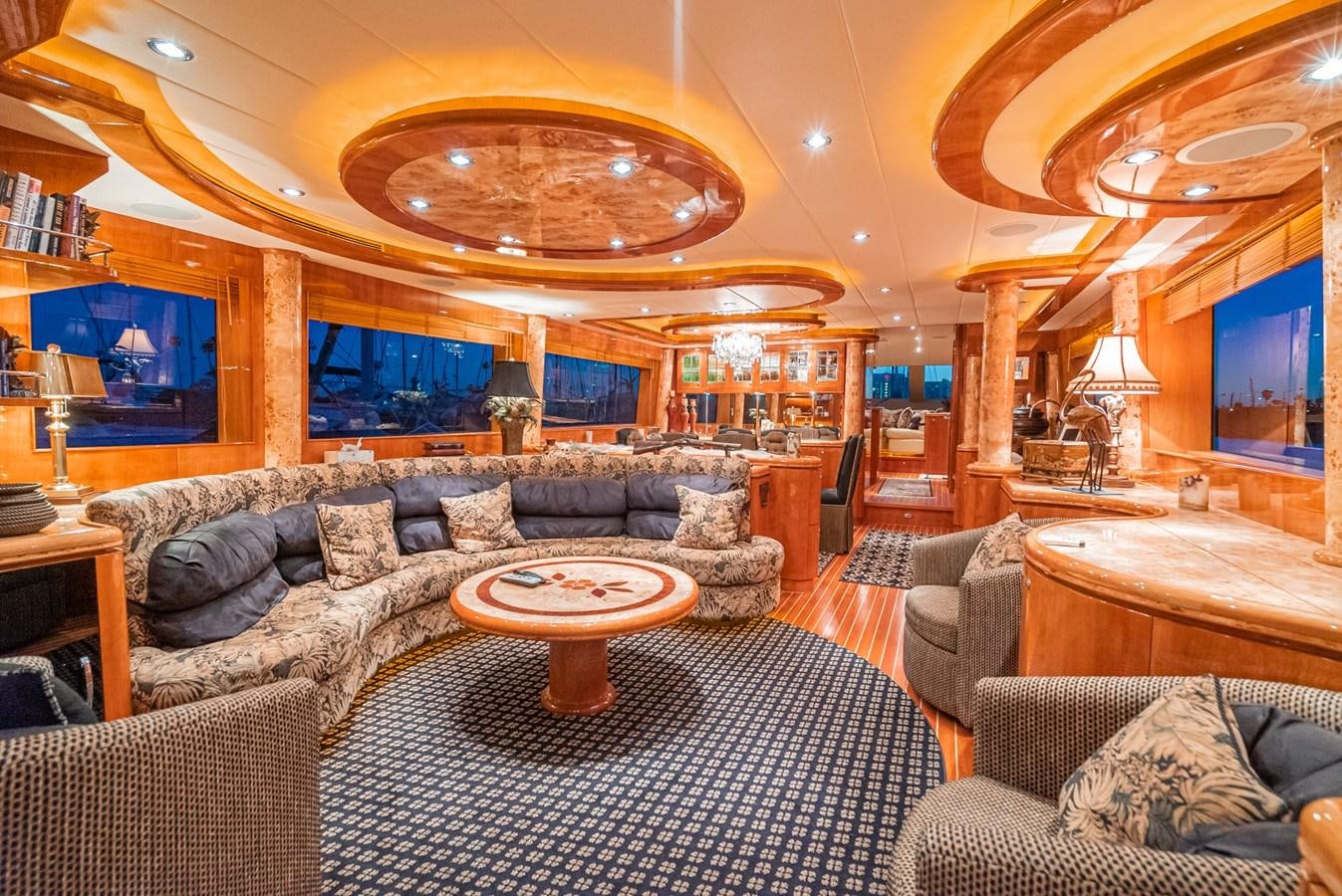 a living room with a large chandelier aboard LIBERTY Yacht for Sale