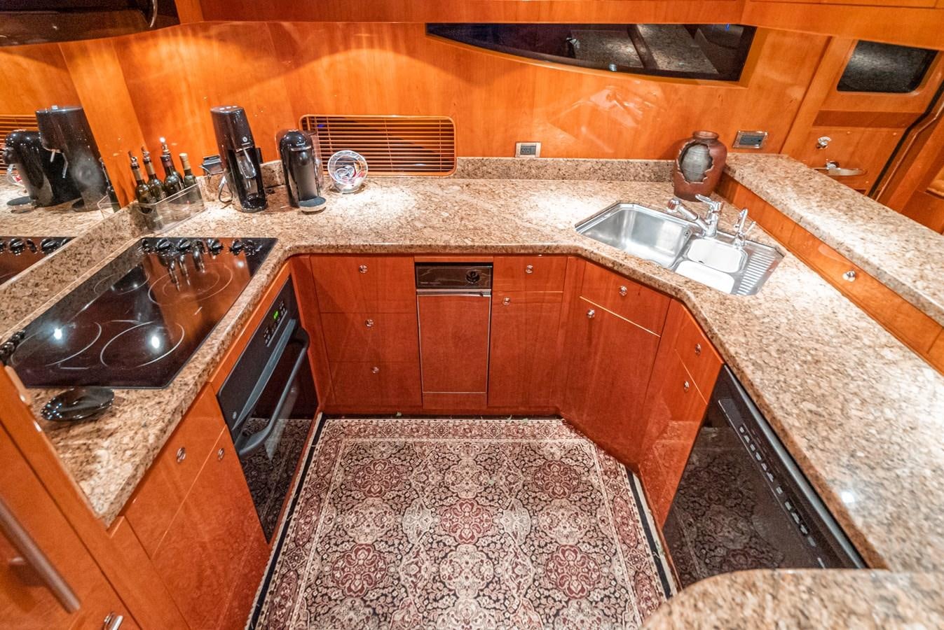a kitchen with wooden cabinets aboard LIBERTY Yacht for Sale