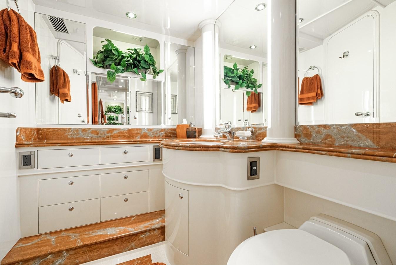 a bathroom with a sink and cabinets aboard LIBERTY Yacht for Sale