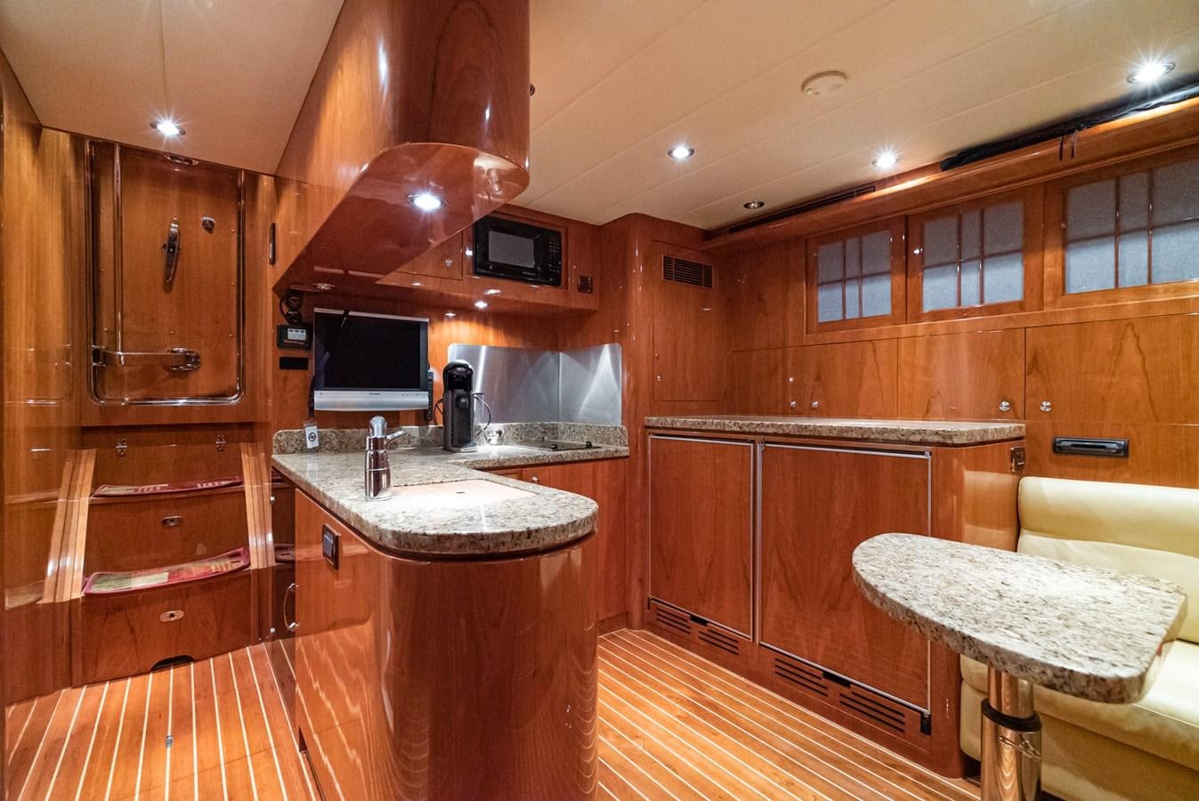 a kitchen with wooden cabinets aboard LIBERTY Yacht for Sale
