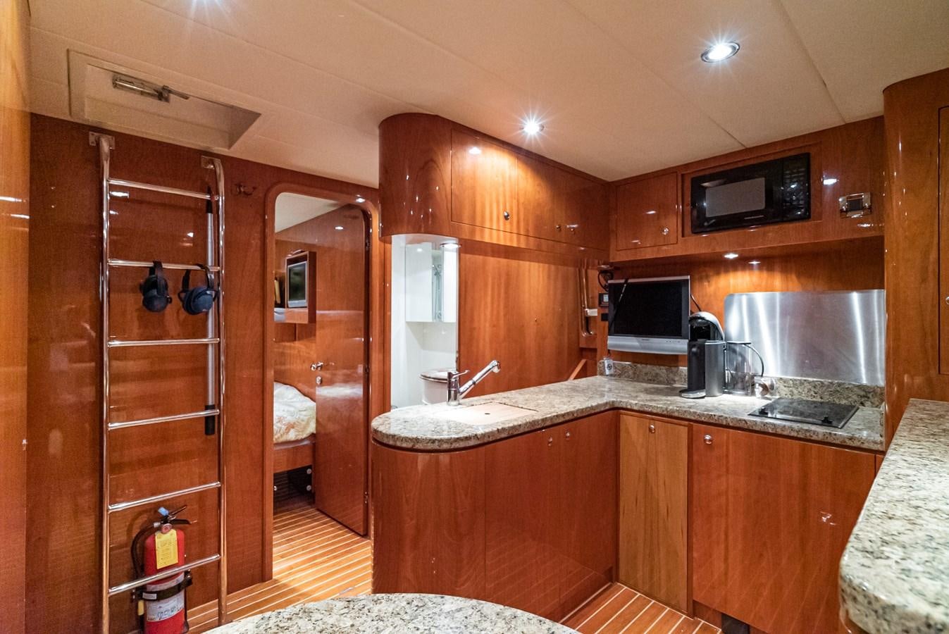 a kitchen with wooden cabinets aboard LIBERTY Yacht for Sale