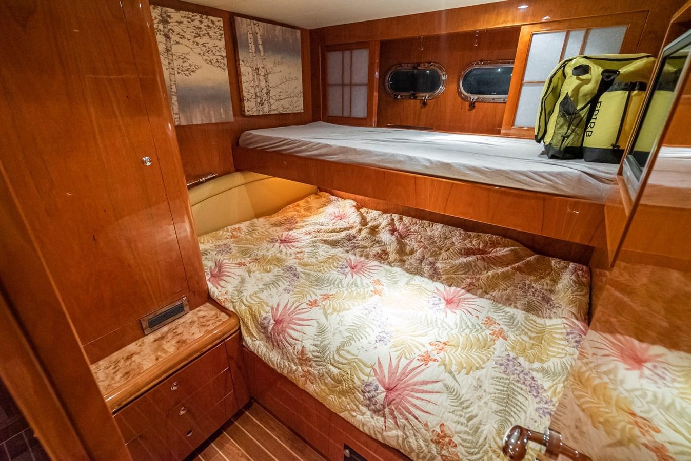a bed with a white sheet aboard LIBERTY Yacht for Sale