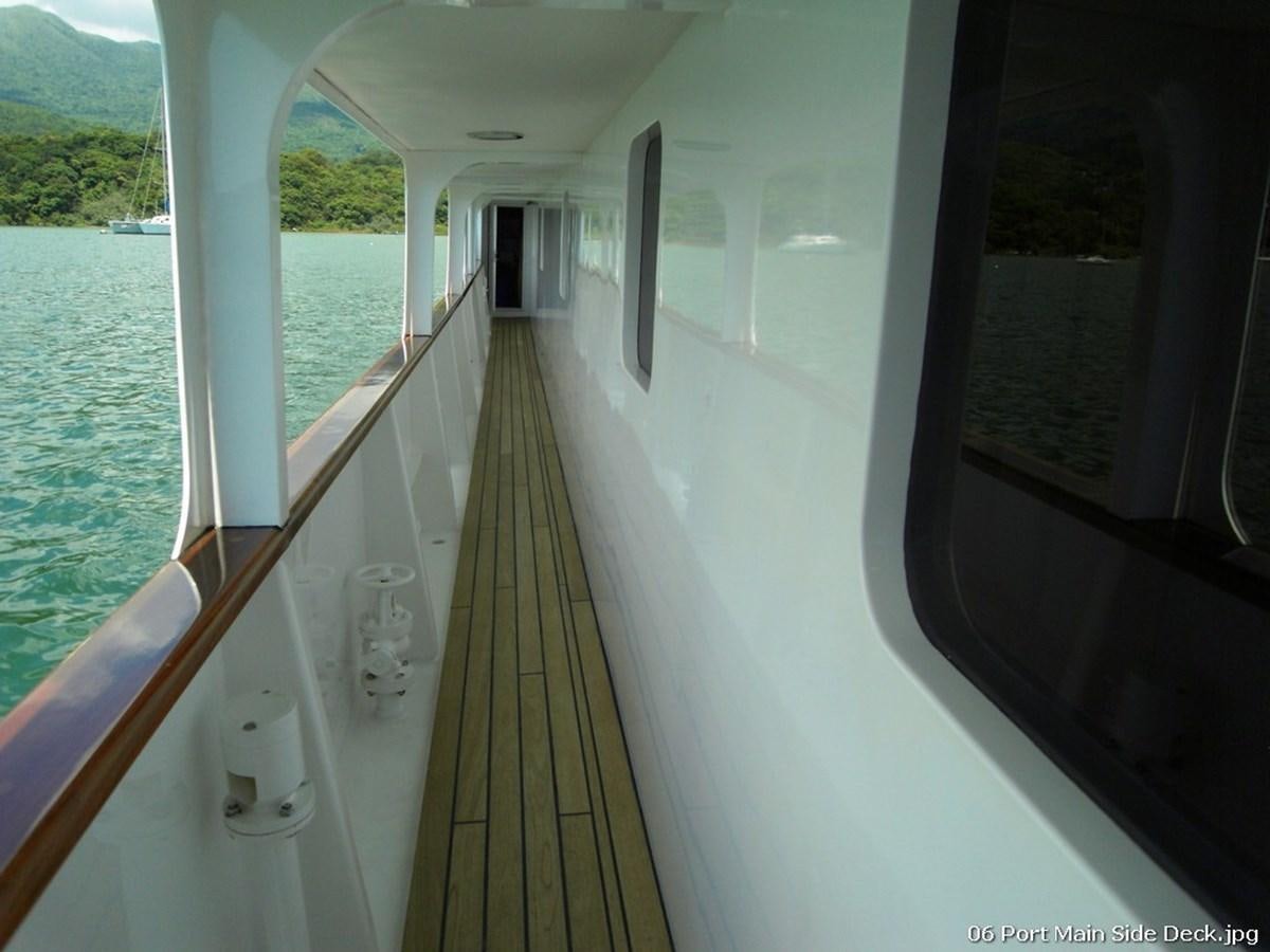 a long hallway with a railing and a railing and a body of water aboard WESTERN ISLES Yacht for Sale