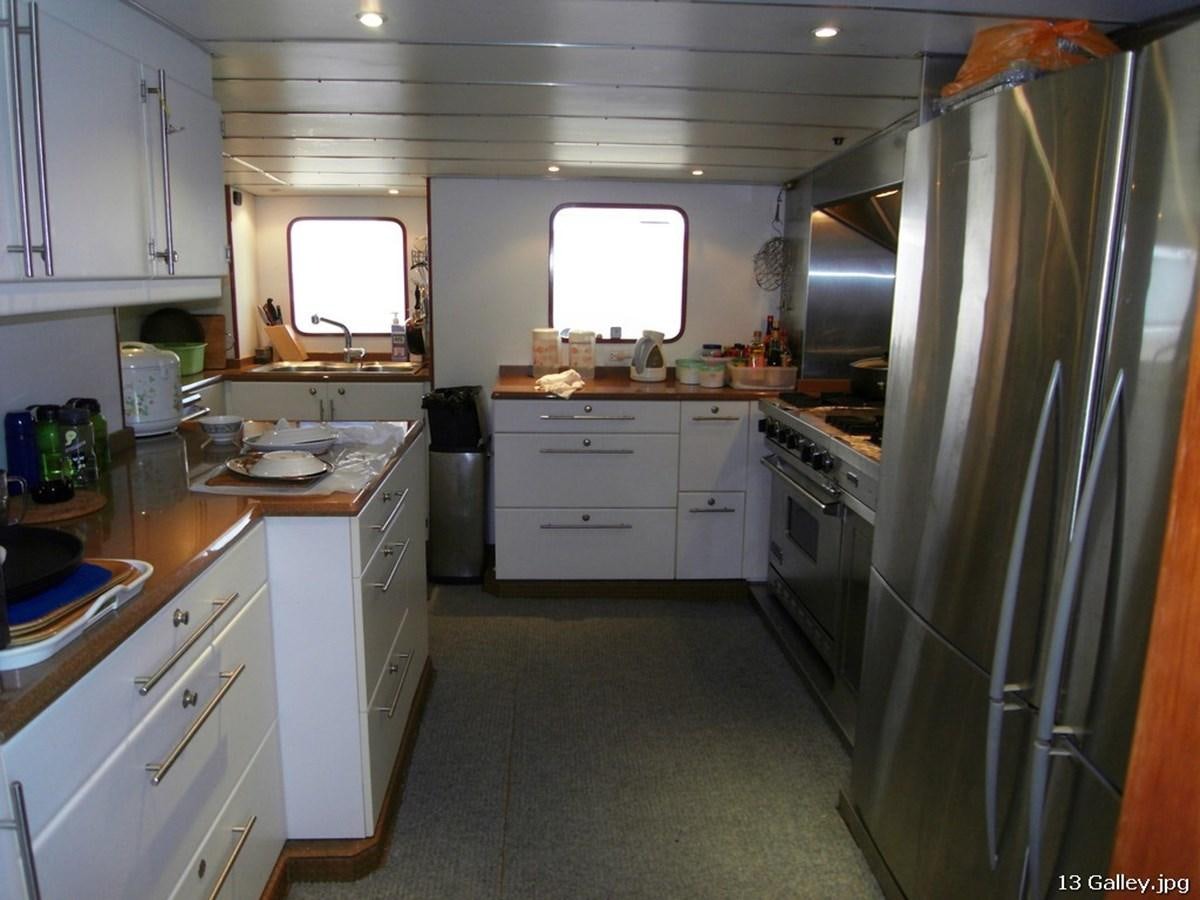 a kitchen with white cabinets aboard WESTERN ISLES Yacht for Sale