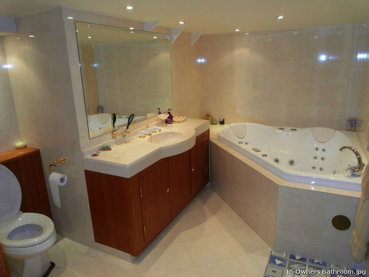 a bathroom with a tub sink and toilet aboard WESTERN ISLES Yacht for Sale