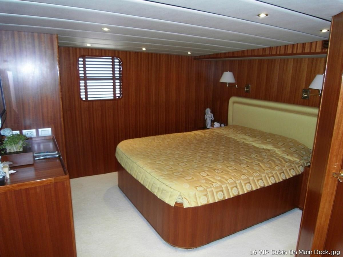 a bedroom with a bed and a desk aboard WESTERN ISLES Yacht for Sale