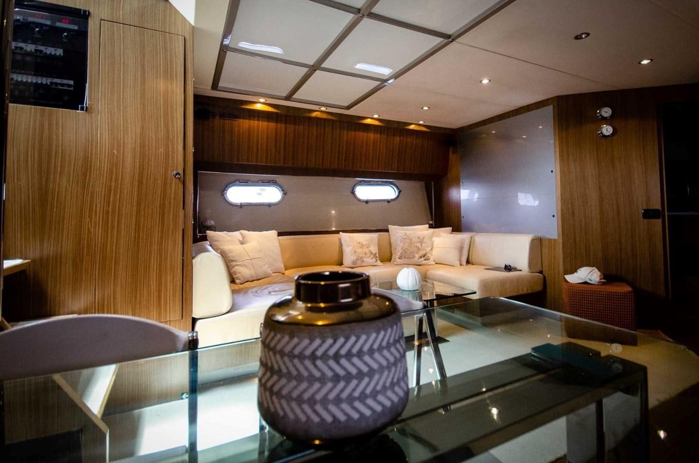 a room with a table and couch aboard ALTER EGO Yacht for Sale