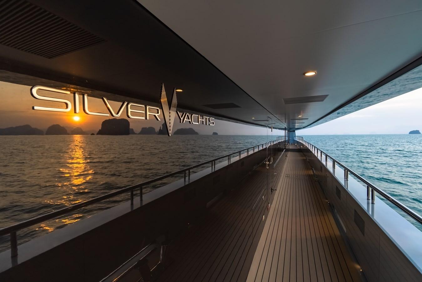 a dock with a body of water and a sunset aboard SPACECAT Yacht for Sale