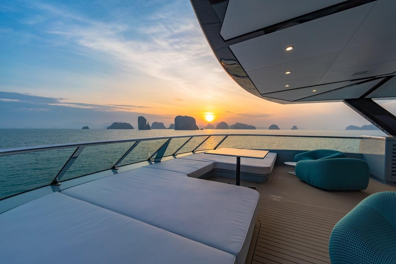 a deck with a view of the ocean and the sunset aboard SPACECAT Yacht for Sale