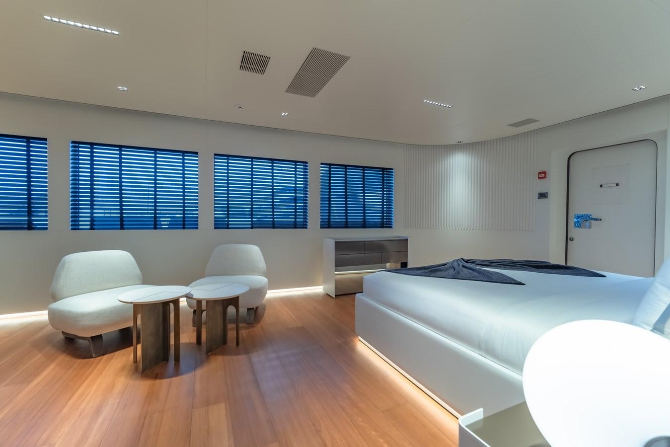 a room with a bed and a table aboard SPACECAT Yacht for Sale